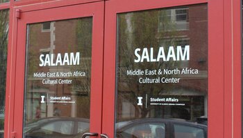 Double exterior doors with the following words printed on the glass: SALAAM Middle East & North Africa Cultural Center
