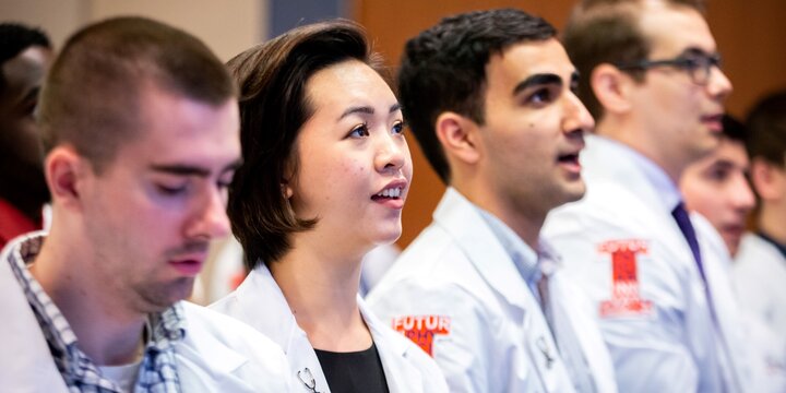 Carle @ Illinois med school students in white coats