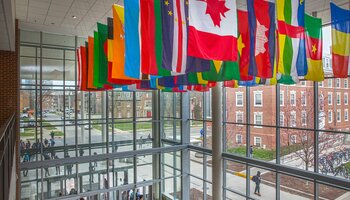 Flags from many nations hang from the ceiling in the Business Instructional Facility lobby on the UIUC campus